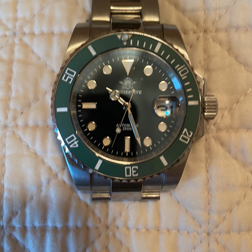 Like a green hulk Rolex but no crowns.  scuba guy. Made by special operators.